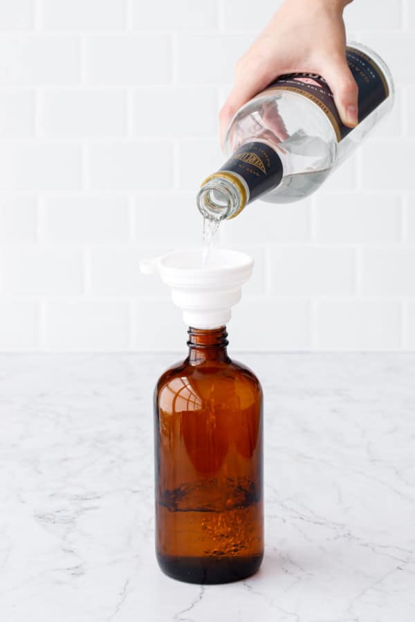 To make Homemade Vanilla Extract, fill an amber glass bottle with alcohol such as vodka, rum, or everclear.