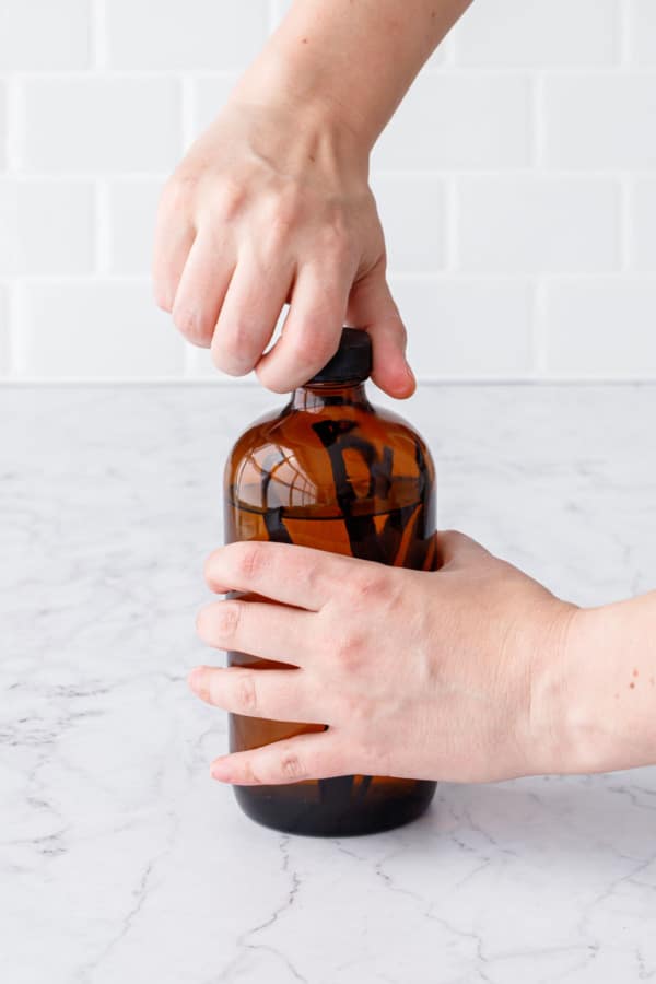 Securing the airtight lid on top of the bottle.