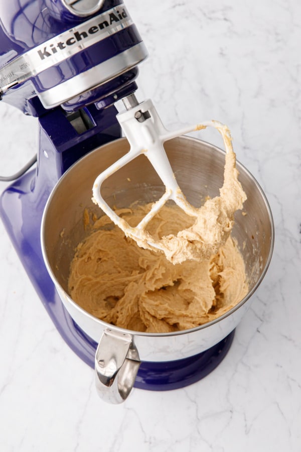 Beater lifted showing the consistency of the batter after beating in the egg.