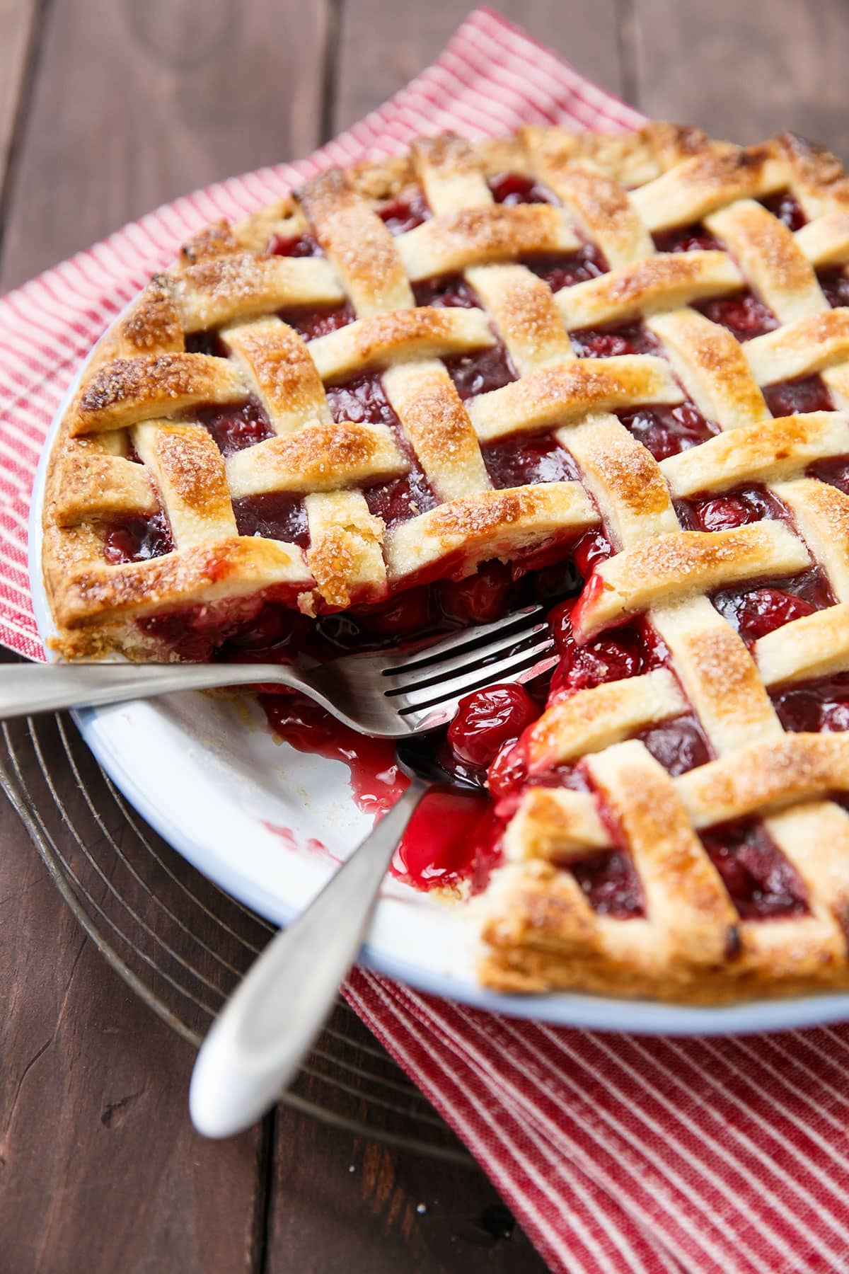 Tart Cherry Pie with one slice taken out and two forks laying in the pie pan.