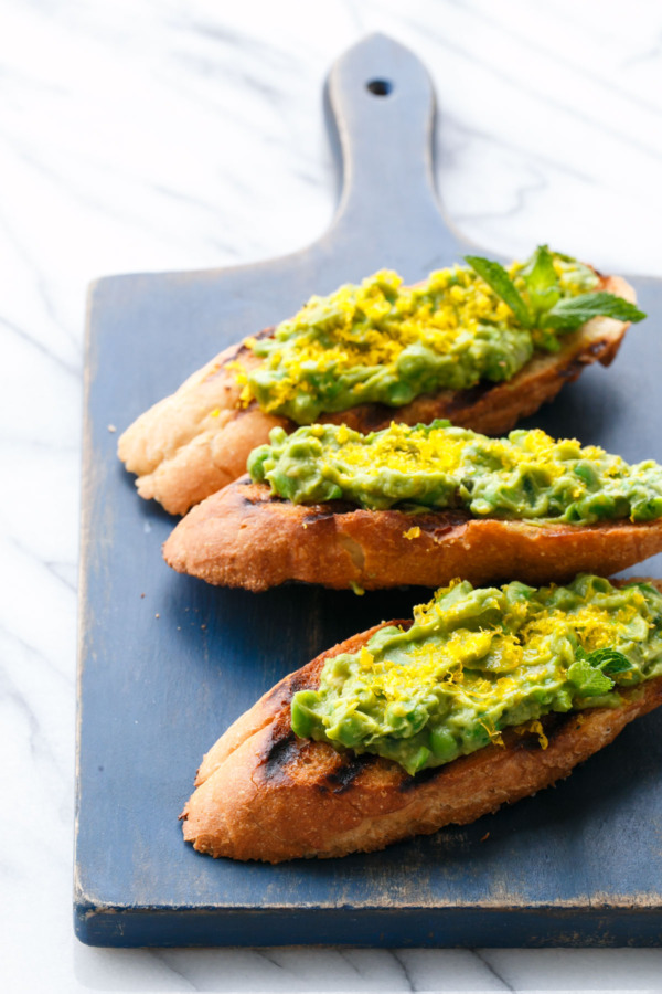 Avocado toast with English peas, mint, and cured egg yolk