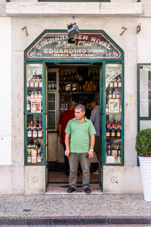 Man standing in the storefront of Ginjinha Sem Rival in Lisbon, Portugal