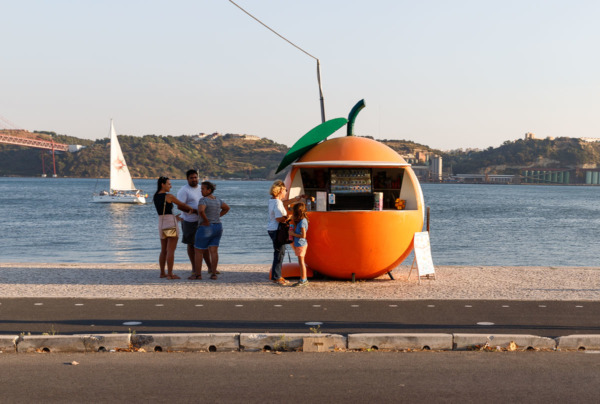 Cute orange-shaped juice stand along the Tagus river in Lisbon, Portugal