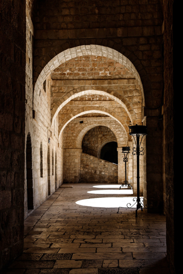 Light streaming through archways inside Fort Lovrijenac in Dubrovnik, Croatia