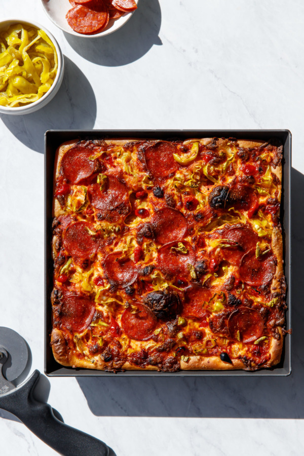 Overhead shot of pepperoni pan pizza with harsh shadows