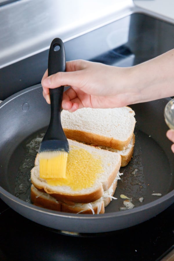 Place egg-side down in a nonstick skillet and brush tops with more egg wash.