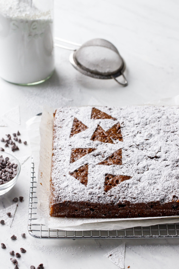 Powdered sugar dusted snack cake with abstract triangle design