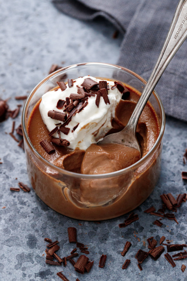 Closeup of Chocolate Pumpkin Pot de Creme in a glass ramekin with spoon
