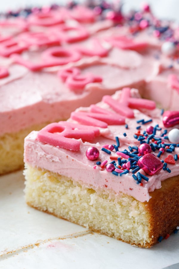 Closeup slice of Classic Yellow Sheet Cake with Strawberry Rose Buttercream Frosting to show texture