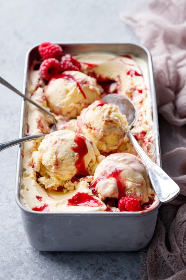 Silver loaf pan with Toast & Jam Ice Cream, messy scoops and multiple spoons.