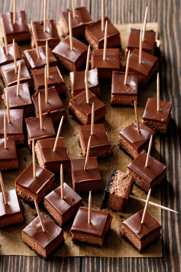 Chocolate Chai Cheesecake Bars cut into bite-size pieces with toothpicks for easy serving