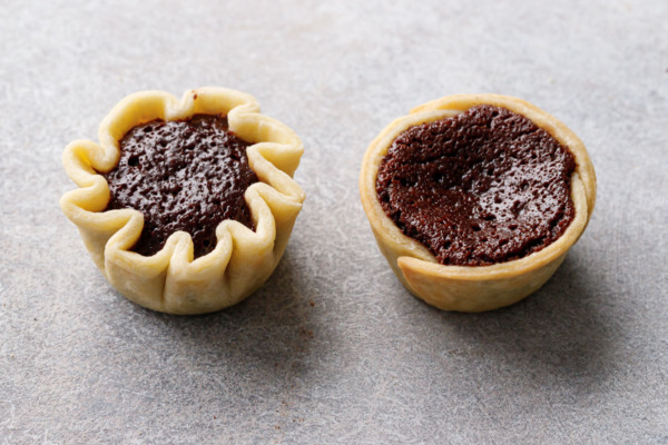 Comparison of two styles of mini pie crusts, crimped on the left and straight sided on the right