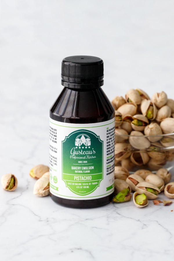 Gusteau's Pistachio Extract bottle with bowl of pistachios.