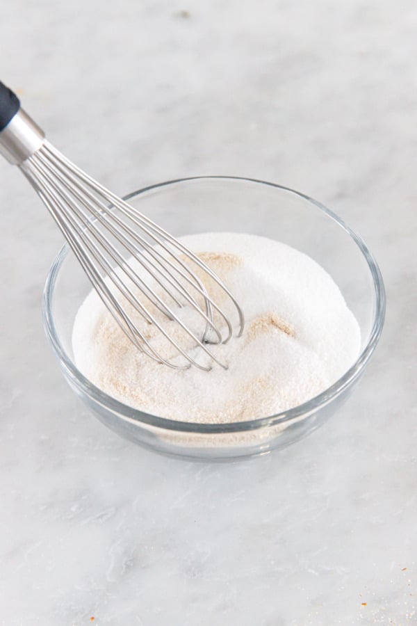 Whisking pectin into granulated sugar which helps it dissolve evenly.