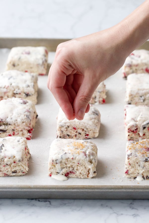 Sprinkling tops of unbaked scones with turbinado sugar after brushing with cream.