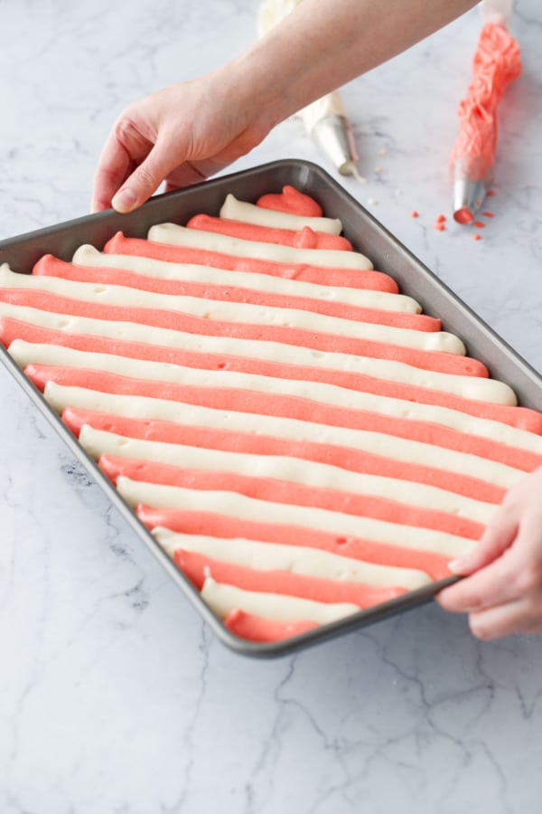 Lifting the striped cake batter in the pan before dropping it to remove the bubbles.