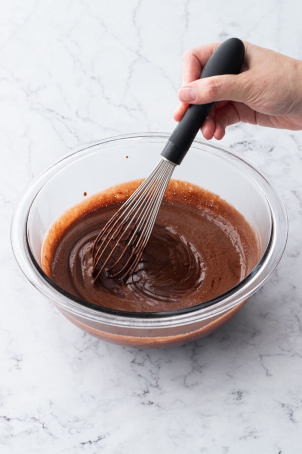 Whisking chocolate mixture until chocolate is fully melted and smooth.
