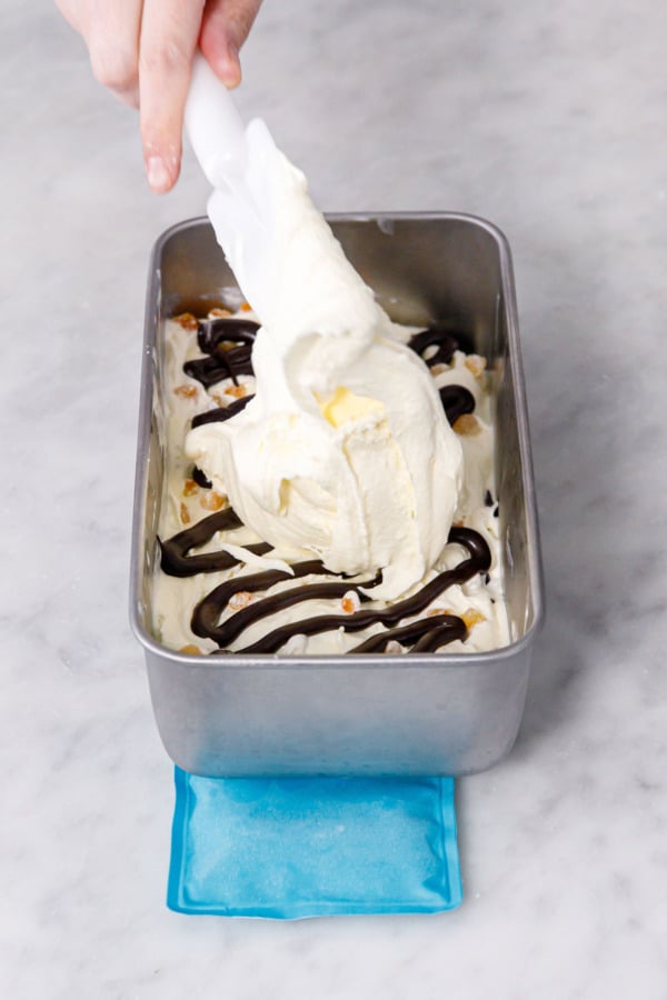 Topping with another layer of ice cream on top of fudge swirl.