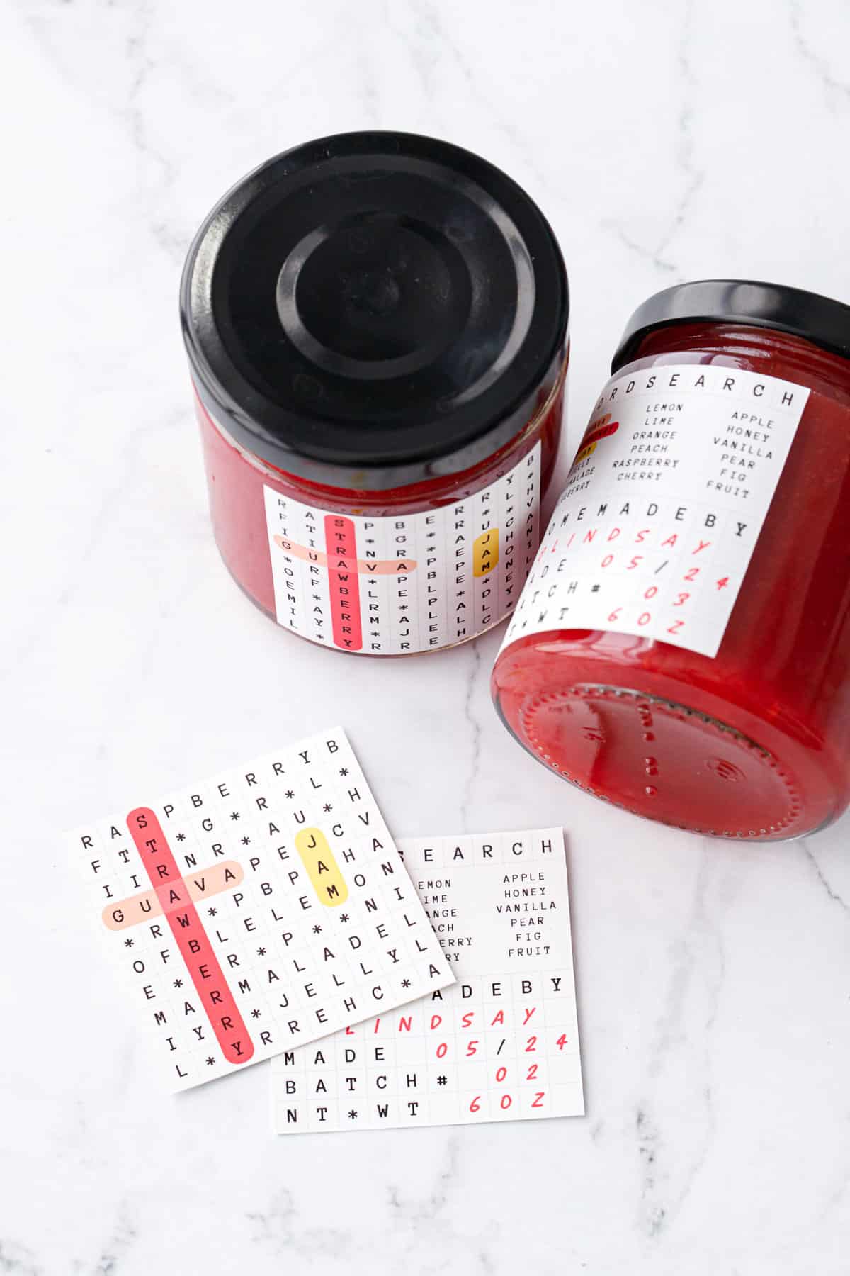 Two jars of Guava Strawberry Jam with crossword puzzle printable labels.