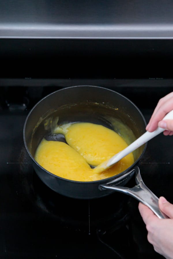 Spatula running through the curd mixture, the trail fills in on itself within a few seconds so it's not quite done yet.