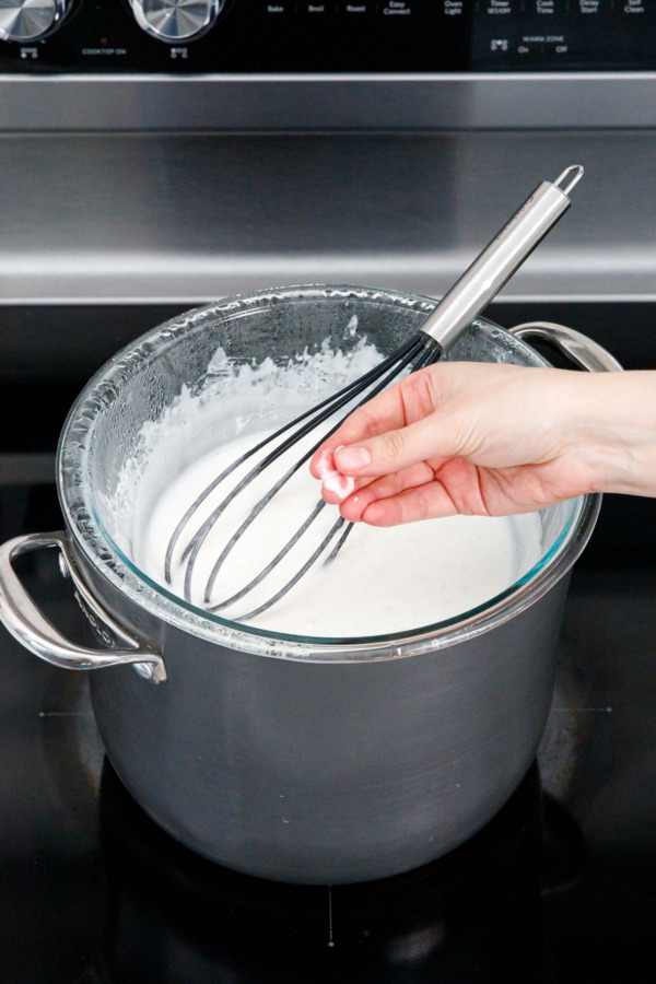 Rubbing a bit of the cooked meringue between fingers to check for any undissolved sugar.