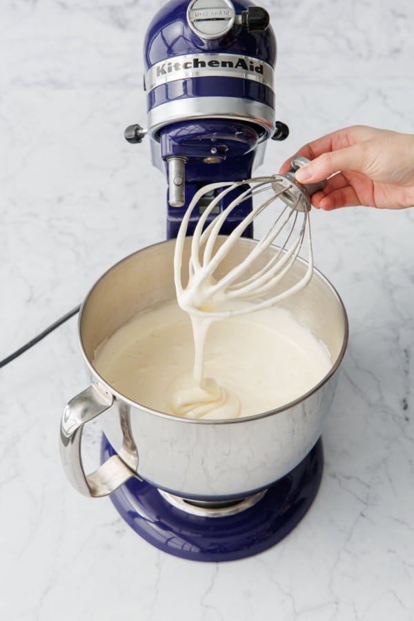Showing the consistency of the egg/sugar mixture after beating it, it should fall off the beater in thick ribbons that slowly dissolve into the rest of the mixture.
