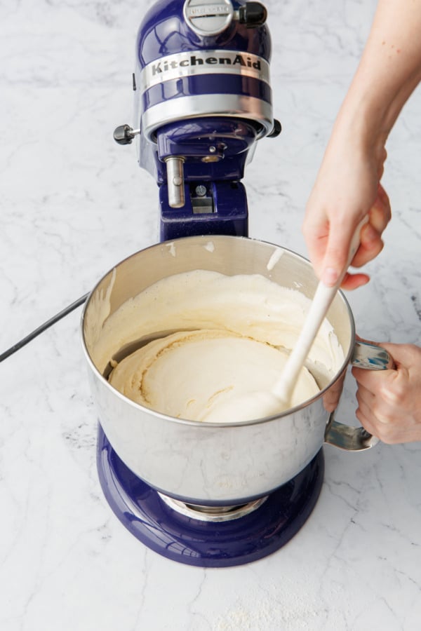 Showing the motion of folding, by first swiping the spatula around the side/bottom of the bowl.