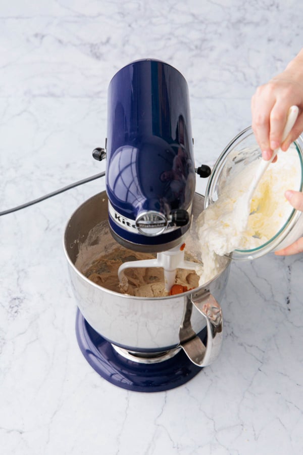 Adding half of sour cream mixture to mixing bowl.