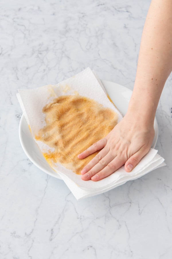 Pat dry pumpkin puree using 2-3 changes of paper towels to remove excess moisture.