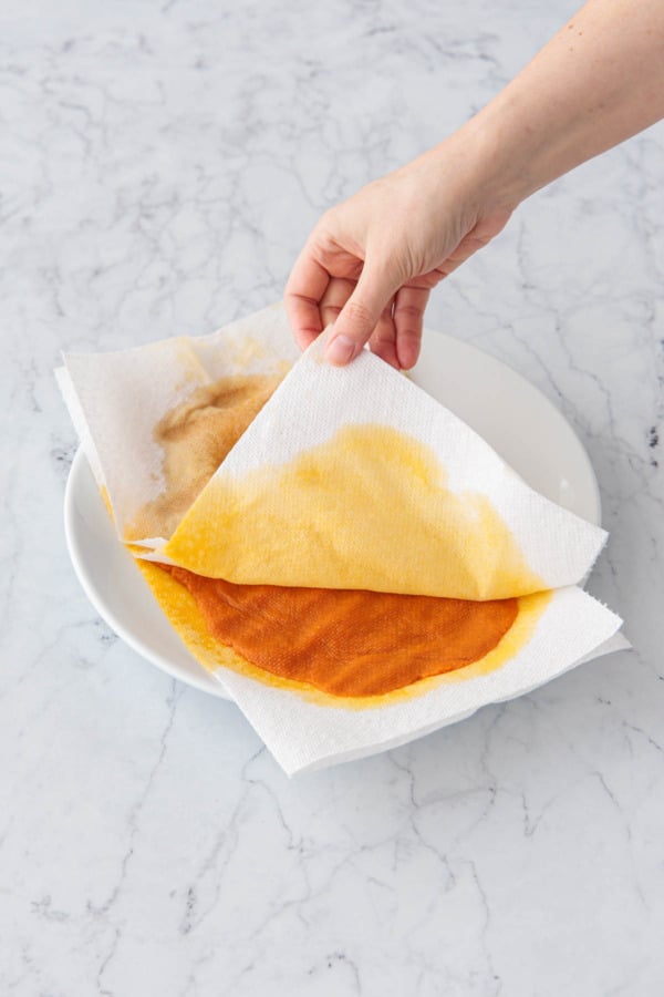 Peeling off the paper towel after absorbing much of the moisture from the pumpkin puree.