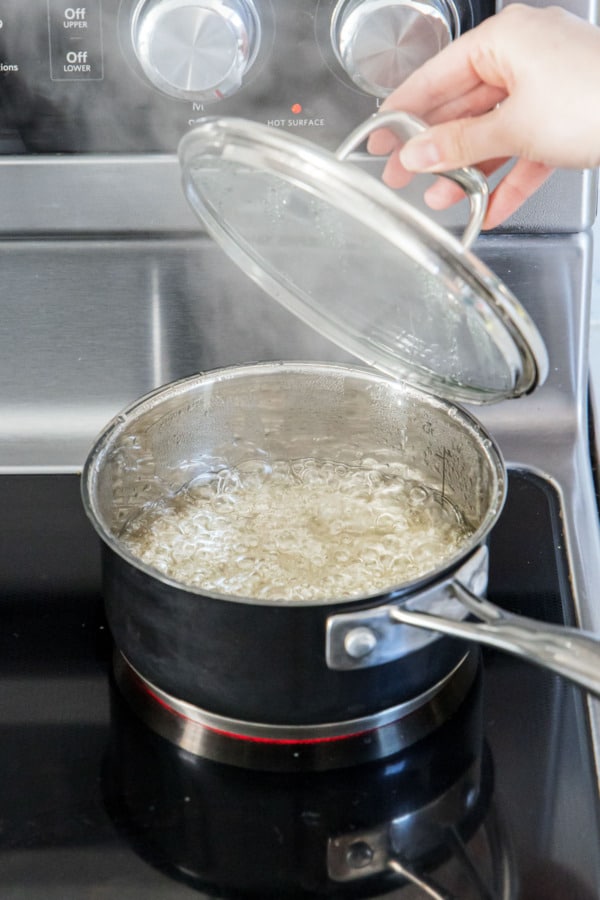 Covering saucepan once it stars to simmer.