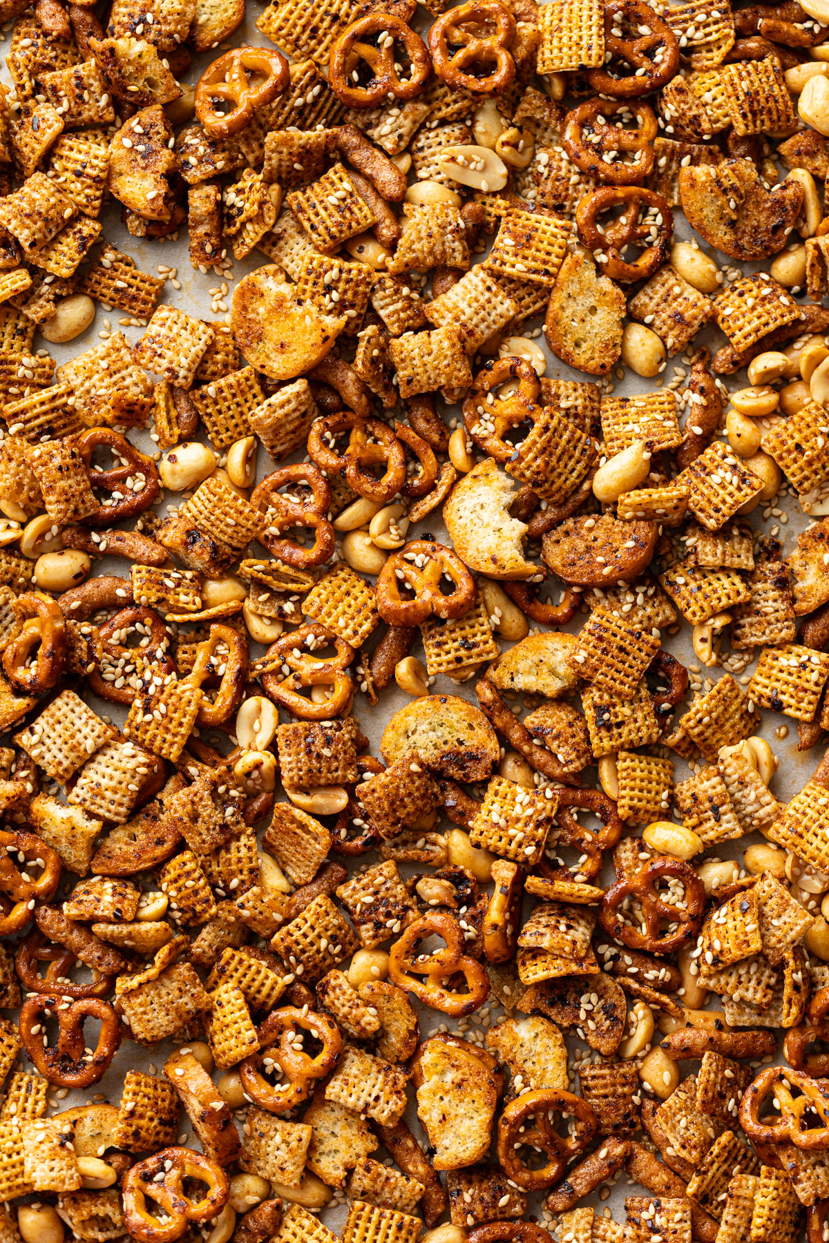 Overhead, sheet pan covered in homemade Sweet & Spicy Sesame Snack Mix.