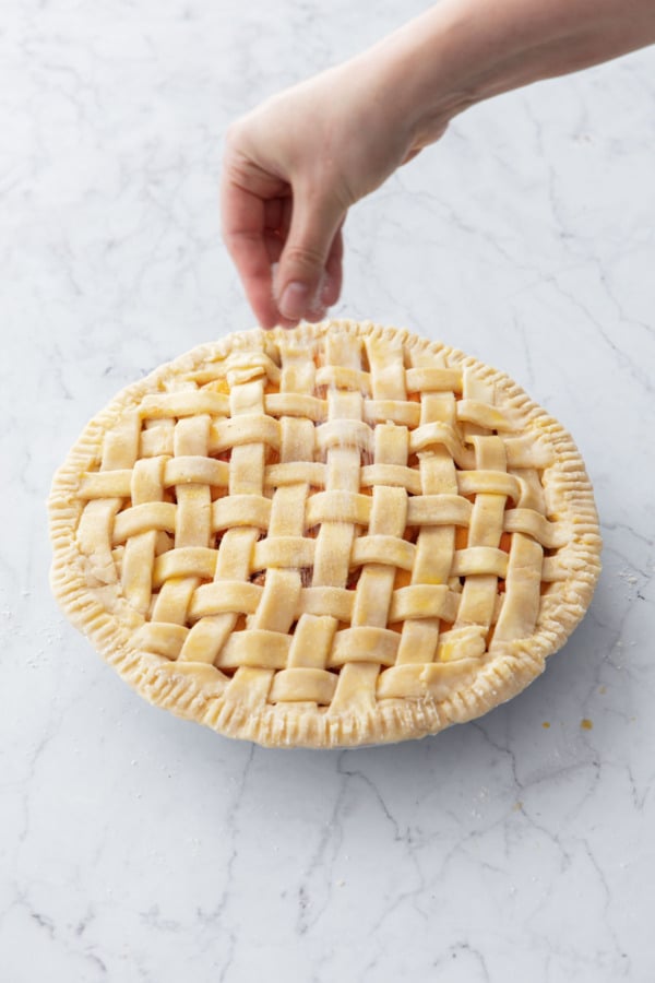 Sprinkling vanilla sugar over top of egg washed pie crust.