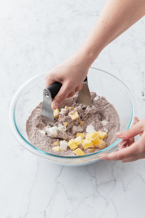 Pastry blender incorporating the cold butter and shortening into the dry ingredients.